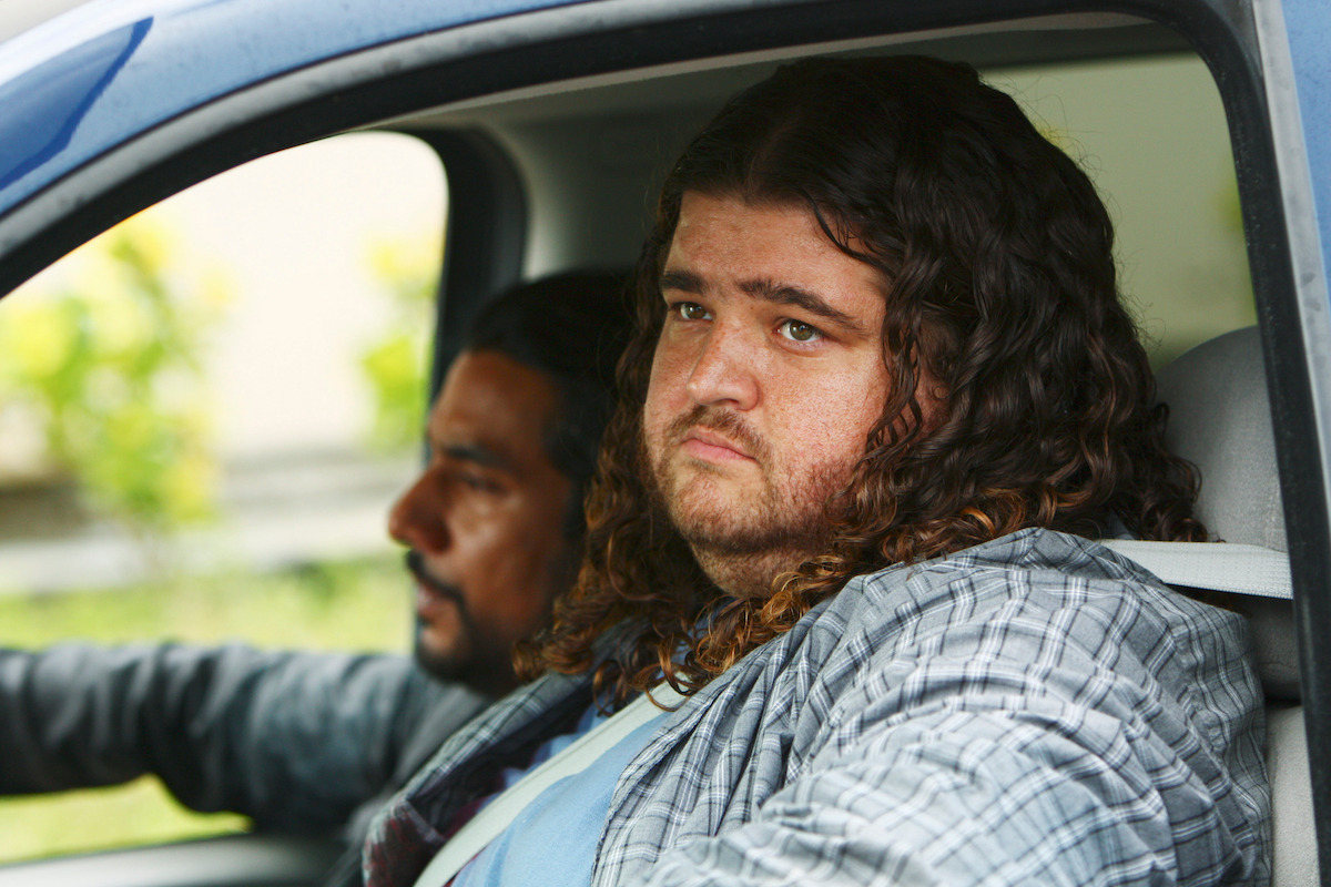 Naveen Andrews as Sayid and Jorge Garcia as Hugo sit in a car.